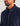 Man wearing navy fleece pullover with quarter-snap neckline and snap buttons down front placket.