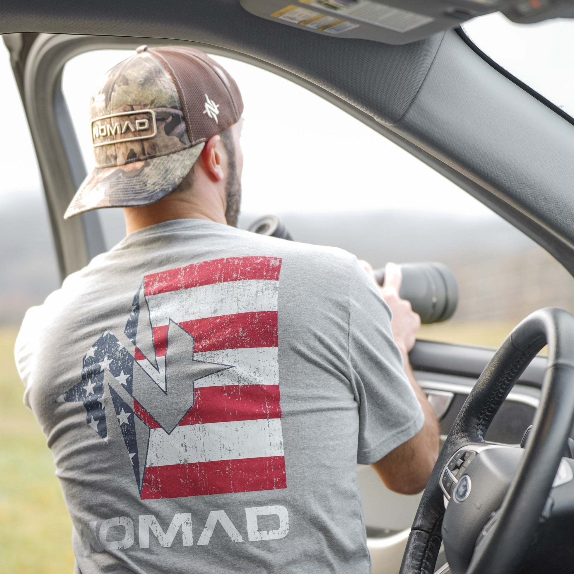 Gray t-shirt with red and white striped flag design and star graphic on back.