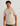 Beige short-sleeve tee with chest pocket featuring circular Huk logo.