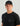 Man wearing black Huk t-shirt with tonal logo and black mesh trucker cap with gray bill.