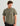 Olive green short-sleeve t-shirt with chest pocket and "HUK Fishing" logo print.
