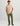 Beige short-sleeve tee with chest pocket featuring red text, styled with olive pants.
