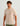 Beige t-shirt with short sleeves, crew neck, and chest pocket featuring orange "HUK" text and smaller text below.