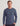 Man wearing blue-gray long sleeve tee with chest pocket and "huk" logo embroidered on front.