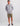 Gray hooded long-sleeve tee with small chest logo and front kangaroo pocket.