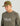 Man wearing olive-green baseball cap with fish embroidery and matching long-sleeve crew shirt with HUK Performance Fishing lo