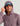 Mauve pullover hoodie with kangaroo pocket and blue baseball cap worn underneath the hood.