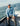 Man wearing light blue long-sleeve crew neck shirt on a boat at sea.