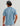 Man wearing slate blue short-sleeve crew neck shirt with "Huk Fishing" text on back, shown from behind with dark cap.