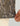 Camouflage patterned crew neck shirt in tan and black with textured fabric, worn on model showing sleeve and torso detail.