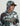 Camouflage hoodie in green, white, and brown with attached hood and brown visor, worn by man against neutral background.