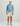 Man wearing blue tie-dye Huk hoodie with white logo and tan shorts.