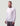 Man wearing light pink long-sleeve tee with HUK Supply Co. logo on chest and dark gray pants.