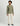 Man wearing sage green long sleeve tee with small chest logo and cream pants.