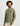 Olive green long sleeve tee with small black logo on chest, worn by model with cream pants.