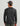 Man wearing black long-sleeve crew neck shirt with camo print pattern, shown from back view.