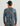 Man wearing black cap and blue-gray printed long-sleeve crew shirt with abstract pattern, rear view.