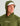 Olive green hoodie with "Huk" logo on chest, shown worn with white and sailboat-print baseball cap.