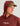 Maroon hoodie with drawstring hood worn with olive cap, featuring white text on chest.