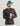Man wearing charcoal textured long sleeve crew neck shirt with small logo on chest.