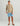 Tan camo long sleeve crew neck shirt with small chest logo worn with blue shorts.