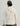 Cream tie-dye hoodie with gray drawstrings, shown from back view on model wearing gray cap.