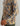 Tan and navy camo printed hoodie with dotted texture and vertical text branding on sleeve.