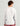Man wearing white long-sleeve crew neck shirt with navy side panels, shown from back view.