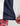 Navy crew neck with white contrast trim and red patterned cuff detail visible at hem.