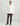Cream-colored fleece shacket with chest pockets and button front, paired with dark pants and olive beanie.