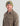 Tan fleece shacket with button front, chest pockets, and brand logo on sleeve.