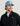 Man wearing black Leeward lightweight fleece 1/4 zip with white undersleve and blue mesh-back baseball cap.