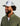Olive green fleece pullover with 1/4 zip neckline and navy trim worn with white camo mesh cap.