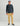 Man wearing charcoal heather hoodie with small logo and tan chinos.