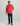 Man wearing red Huk hoodie with large logo, dark jeans, and tan boots.
