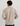 Beige cotton fleece pullover with 1/4 zip collar and ribbed cuffs, shown from back view on male model.