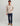 Man wearing beige cotton fleece 1/4 zip pullover with kangaroo pocket and navy pants.
