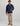 Man wearing navy 1/4 zip fleece with front pocket and tan chinos.