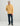 Tan terry hoodie with HUK logo and kangaroo pocket, worn with navy pants and cap.