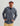 Man wearing blue tie-dye 1/2 zip fleece hoodie with kangaroo pocket over black shirt and tan pants.