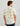 Men's short-sleeve button-down shirt with cream base and green sailboat and fish print throughout.
