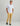 Man wearing light blue button-down short-sleeve shirt with khaki pants and black sneakers.