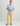 Man wearing light blue button-down shirt with leaf print and khaki pants.