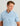 Light blue button-down shirt with all-over fish print, short sleeves, worn by man against neutral background.