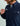 Navy blue corduroy button-down shirt with chest pocket and plaid lining visible on collar.
