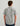 Man wearing gray short-sleeve button-down shirt with white tropical and nautical print, shown from back.