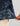 Navy and black tie-dye patterned short sleeve button-down shirt with small circular print details.