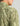 Sage green button-down shirt with abstract printed pattern on back and dotted texture on front panel, shown on model from sho