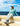 Huk men's Watershed Hoodie Shirt in Mineral Blue Heather, moisture-wicking long-sleeve fishing hoodie, worn on the water