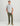 Man wearing white and blue plaid short sleeve button-up shirt with chest pocket and olive pants.